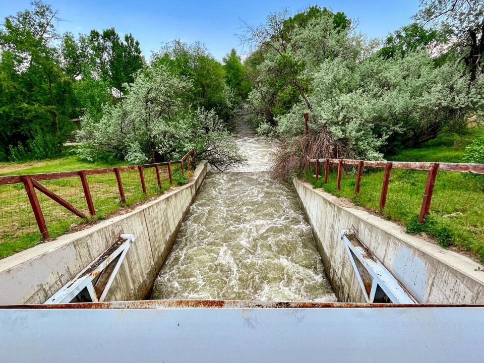 Water flows from a small dam at Wheeler Historic Farm in Murray on Monday. 