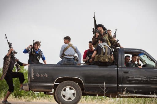 Members of the Free Syrian Army's "Commandos Brigade" on patrol near Qusayr, on May 10. The UN has condemned mass slaughter near the central town of Houla on Friday and Saturday in which 108 people died, including 49 children and 34 women