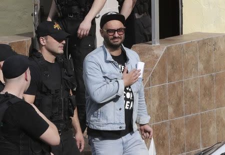 Russian theatre director Kirill Serebrennikov (R), who was accused of embezzling state funds, is escorted outside a court building after a hearing on his detention in Moscow, Russia August 23, 2017. REUTERS/Tatyana Makeyeva