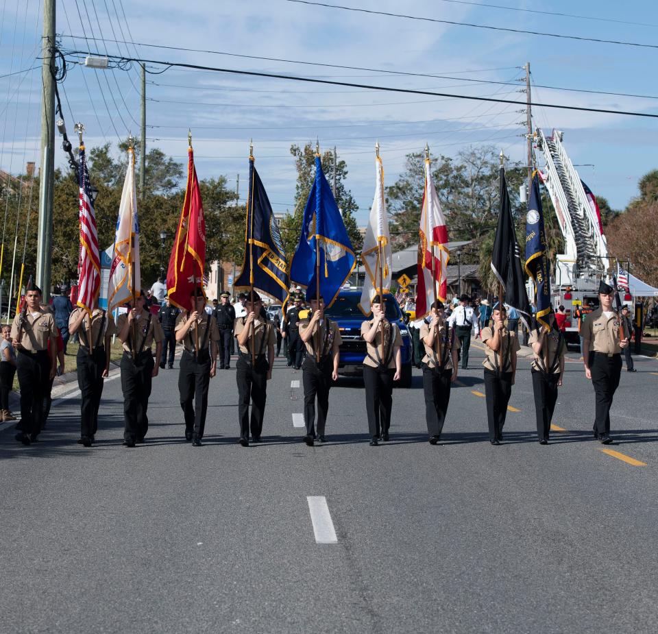 Veterans groups, members of law enforcement, civic organizations, high school ROTC units, marching bands, and politicians march along Bayfront Parkway on Nov. 11, 2021, during the annual Veterans Day parade in Pensacola.