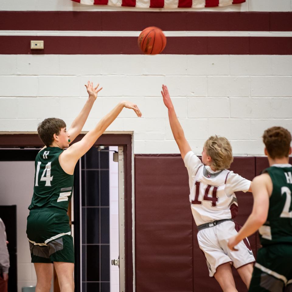 Hamilton's Drew Baker takes a shot over Oriskany's Edward Wright at Oriskany Junior-Senior High School in Oriskany on Saturday, January 21, 2023.