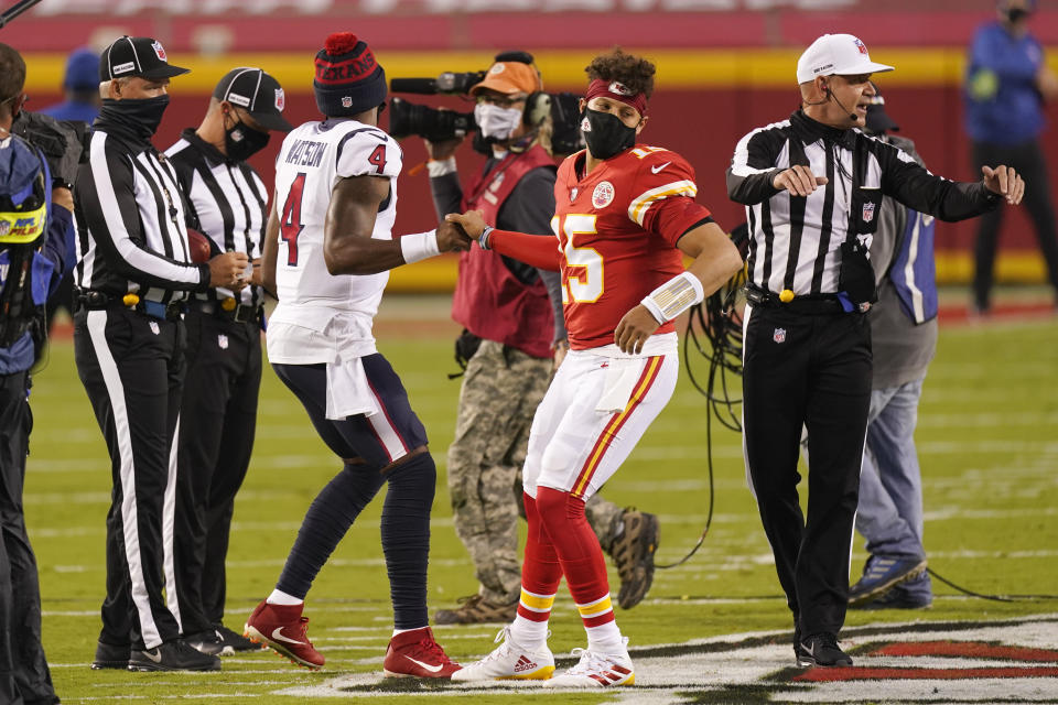 Houston Texans quarterback Deshaun Watson (4) and Kansas City Chiefs quarterback Patrick Mahomes (15) meet on the field during the coin toss before the start NFL football game Thursday, Sept. 10, 2020, in Kansas City, Mo. (AP Photo/Charlie Riedel)