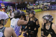 Members of the Long Island Roller Rebels, practice skills, Tuesday, March 19, 2023, at United Skates of America in Seaford, N.Y. (AP Photo/Jeenah Moon)