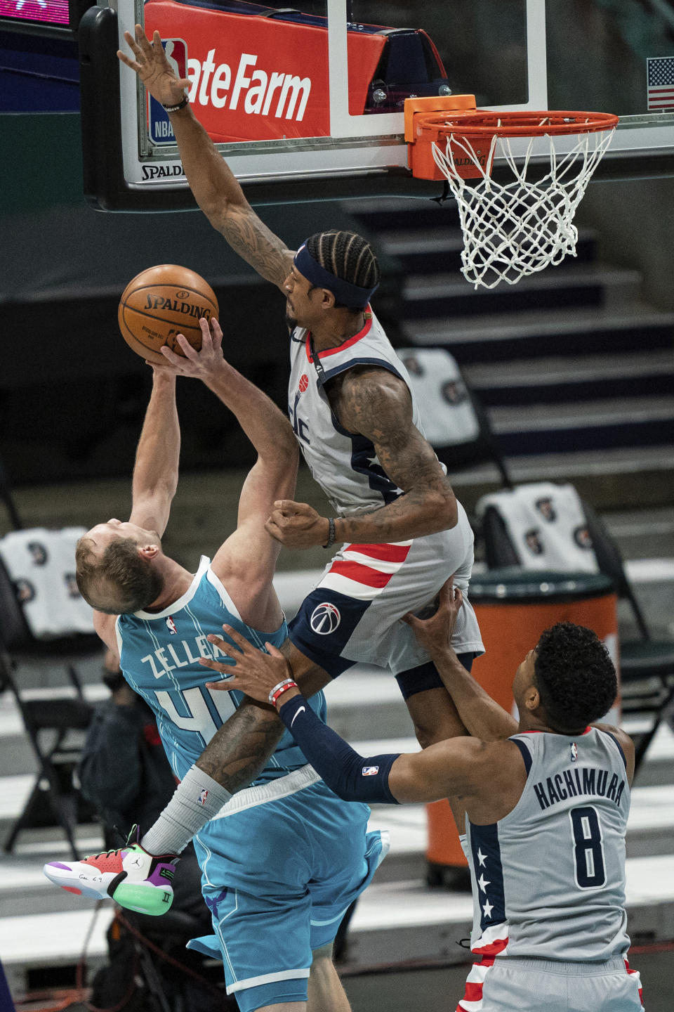 Washington Wizards guard Bradley Beal, top right, tries to block a shot from Charlotte Hornets center Cody Zeller (40) with Wizards forward Rui Hachimura (8) running in to help during the first half of an NBA basketball game in Charlotte, N.C., Sunday, Feb. 7, 2021. (AP Photo/Jacob Kupferman)