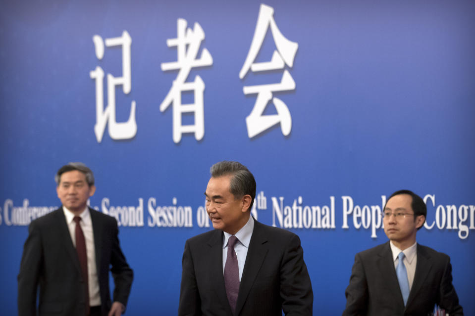 Chinese Foreign Minister Wang Yi, center, leaves after a press conference on the sidelines of the annual meeting of China's National People's Congress (NPC) in Beijing, Friday, March 8, 2019. The U.S.-North Korea summit in Vietnam last week was an "important step" toward denuclearization on the Korean peninsula, China's foreign minister said Friday. (AP Photo/Mark Schiefelbein)