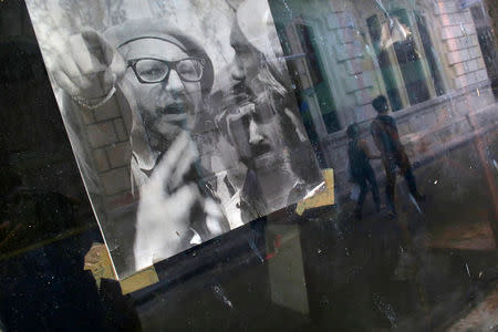 A picture of Fidel Castro is seen on the window of a local shop, following the announcement of the death of the Cuban revolutionary leader, in Havana, Cuba November 27, 2016. REUTERS/Carlos Barria