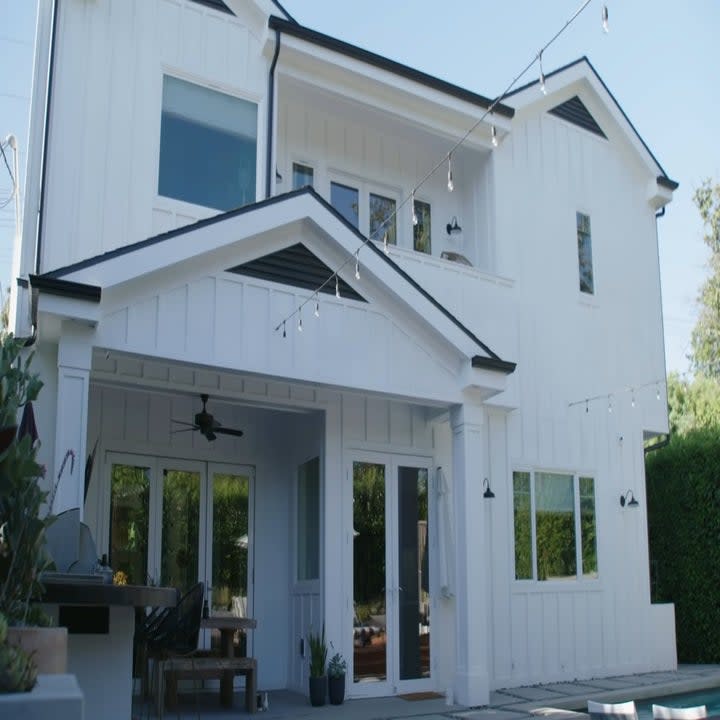 The house is a modern white two-story house