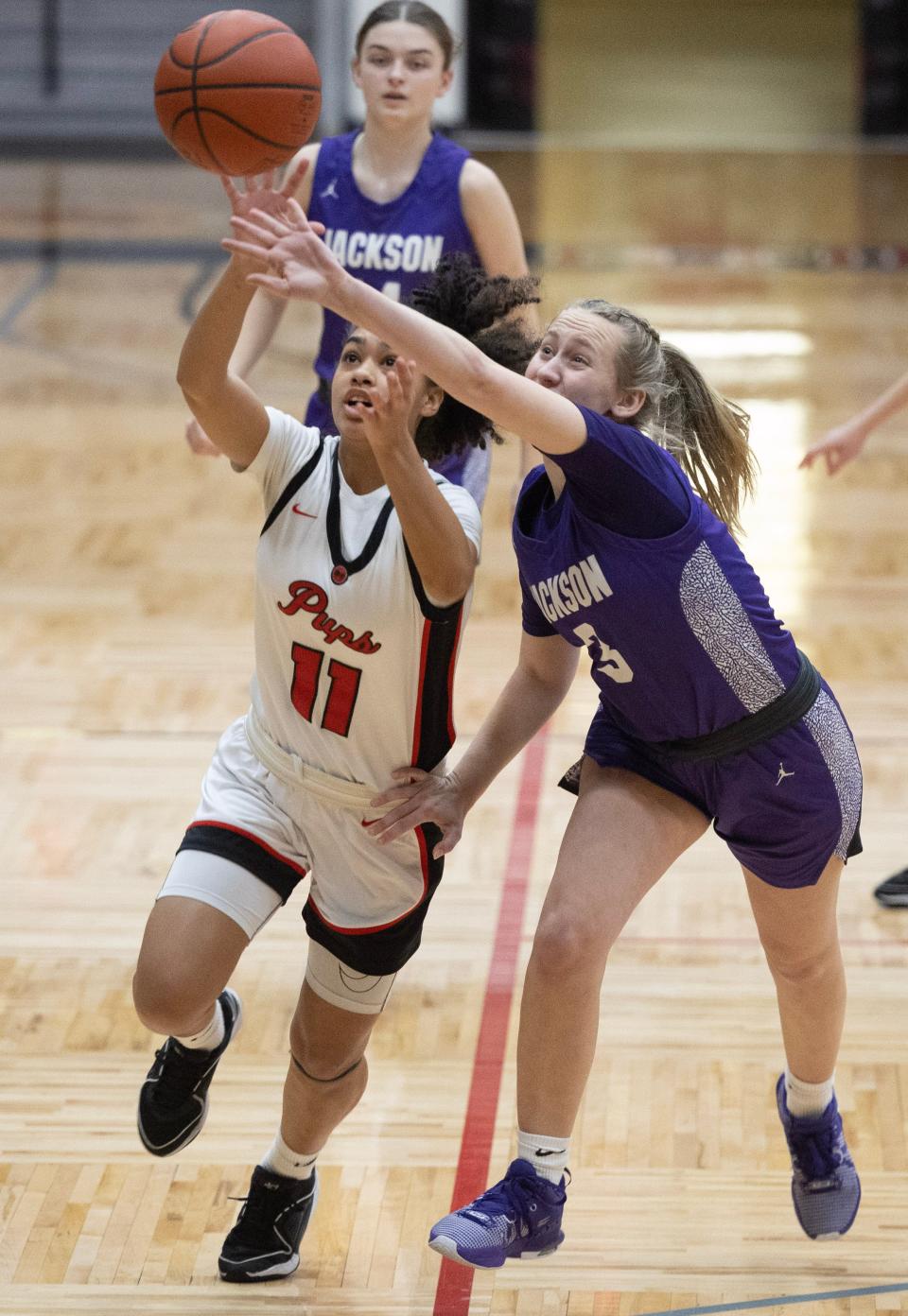 McKinley's Mya Taylor, left, and Jackson's Emily Rofe fight for a loose ball in the first half, Wednesday, Jan. 10, 2024.
