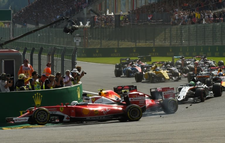 The cars of Red Bull's Max Verstappen and Ferrari's Sebastian Vettel collide after the start of the Belgian Grand Prix in Spa on August 28, 2016