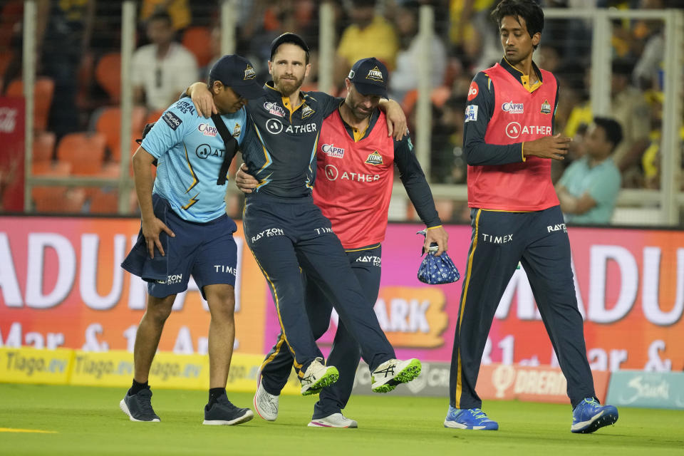 Gujarat Titan's Kane Williamson is carried off the field after he got injured while fielding during their Indian Premier League (IPL) match against Chennai Super Kings in Ahmedabad, India, Friday, March 31, 2023. (AP Photo/Ajit Solanki)