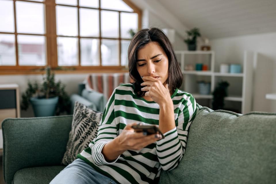 Person contemplating with phone.