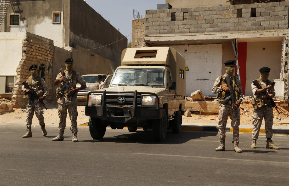 Libyan army forces and vehicles are stationed in a street in the country’s capital of Tripoli on Friday, July 22 2022. One of Libya’s rival governments on Friday called on militias to stop fighting, after clashes broke out in the country’s capital, Tripoli overnight, killing at least one civilian and forcing around 200 people to flee the area. (AP Photo/Yousef Murad)