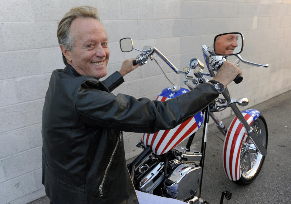 Actor Peter Fonda, star of the 1969 counterculture film "Easy Rider," poses atop a Harley-Davidson motorcycle in Glendale, Calif. The son of Hollywood legend Henry Fonda and brother of actress Jane Fonda, died on Aug. 16 at age 79. (AP Photo/Chris Pizzello)