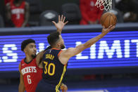 Golden State Warriors guard Stephen Curry shoots next to Houston Rockets guard KJ Martin during the second half of an NBA basketball game in San Francisco, Saturday, April 10, 2021. (AP Photo/Jed Jacobsohn)