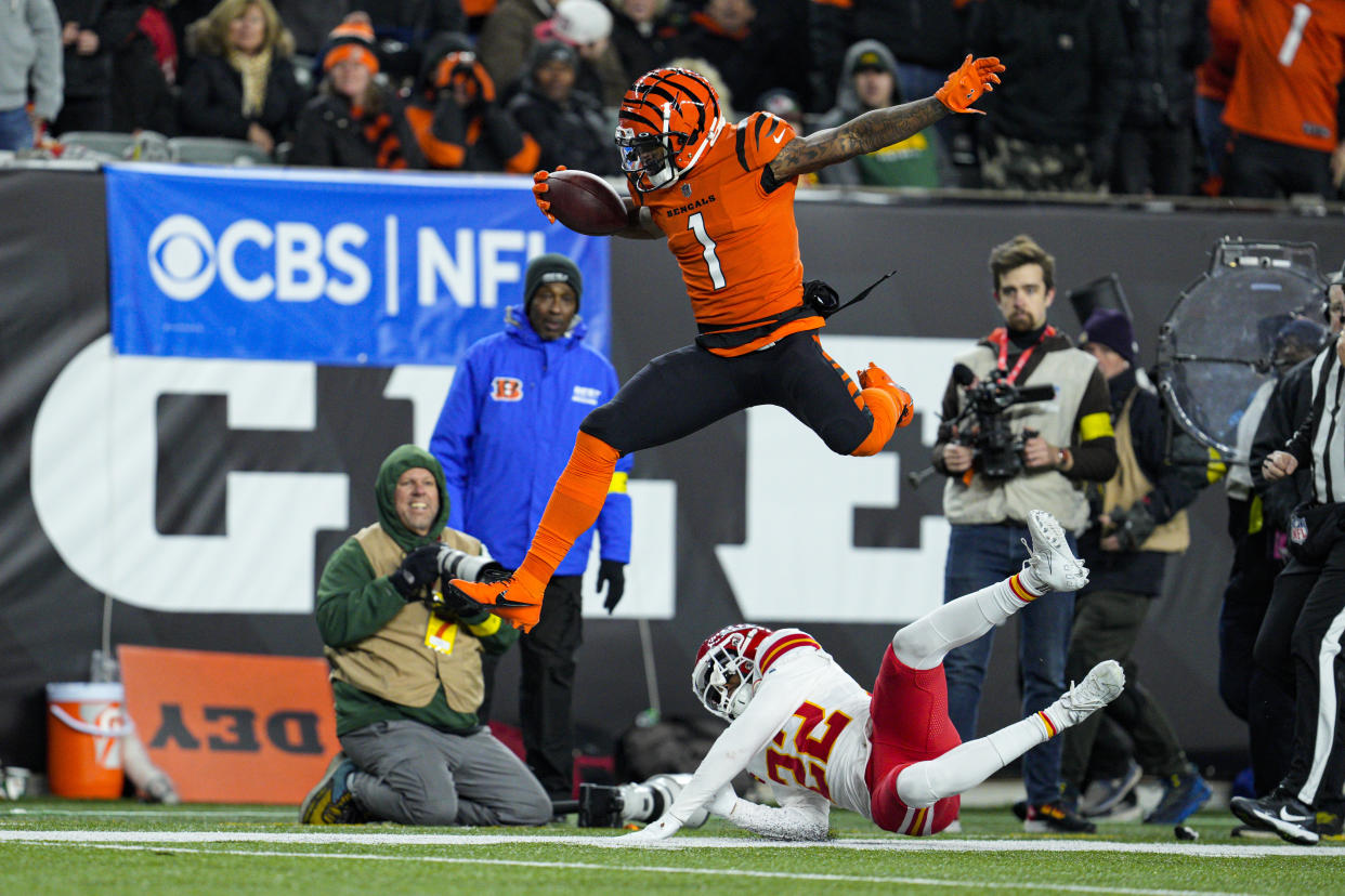 Cincinnati Bengals wide receiver Ja'Marr Chase (1) leaps over Kansas City Chiefs safety Juan Thornhill (22). (AP Photo/Jeff Dean)