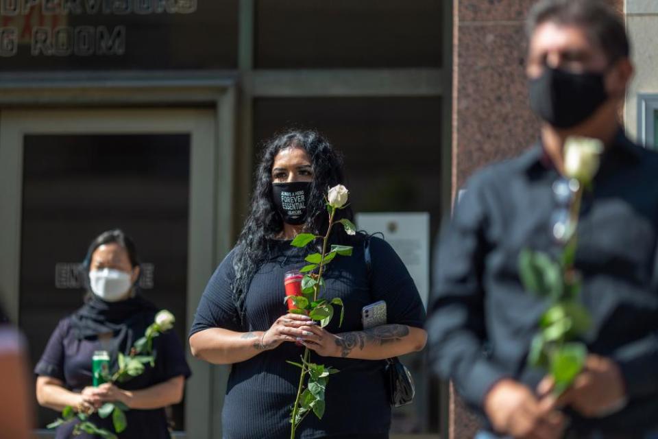 Mourners attend a memorial ceremony held by loved ones of mostly Latino essential workers killed by Covid in Los Angeles on 31 August 2020.