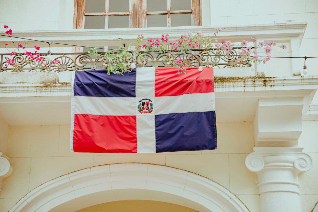 The Dominican Republic is a very popular travel destination but some travelers may have safety concerns. Check out this critical information for travelers. pictured: the Dominican Republic flag posted on.a balcony