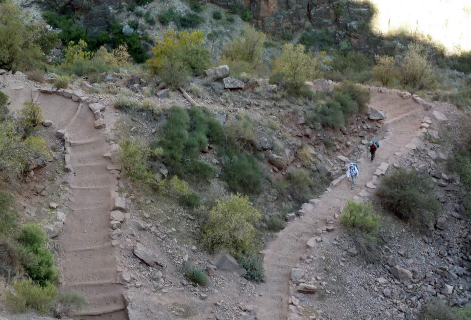 File-This Wednesday, Sept. 29, 2010 file photo shows a switchback on Bright Angel Trail in Grand Canyon National Park, Ariz. About 4.5 million people visit the Grand Canyon every year, but most visit in summer and relatively few venture below the rim. The start of one of the Grand Canyon's most iconic and popular trails has been redesigned and now includes an etched rock sign marking the Bright Angel trailhead. (AP Photo/Carson Walker,File)