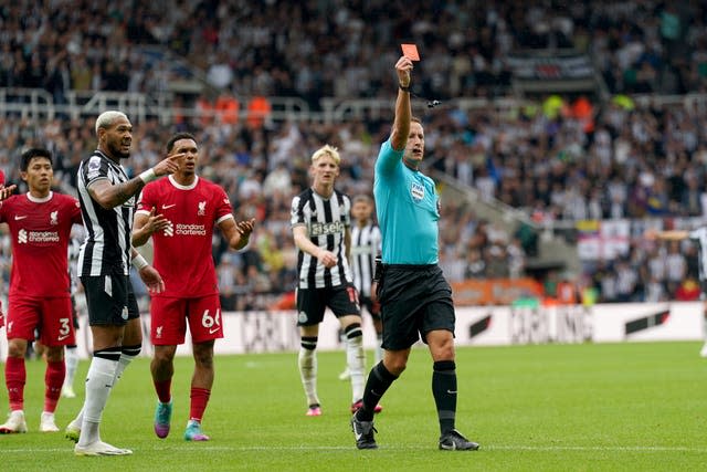 Referee John Brooks shows a red card