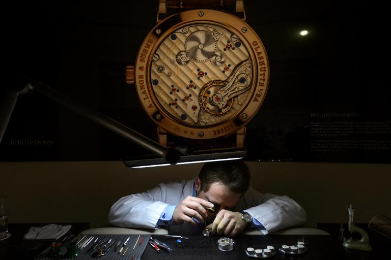 An employee of German watchmaker A. Lange & Soehne assembles a wristwatch on January 19, 2015, during the opening day of the "Salon International de la Haute Horlogerie", a professional fair in fine watchmaking, in Geneva, Switzerland