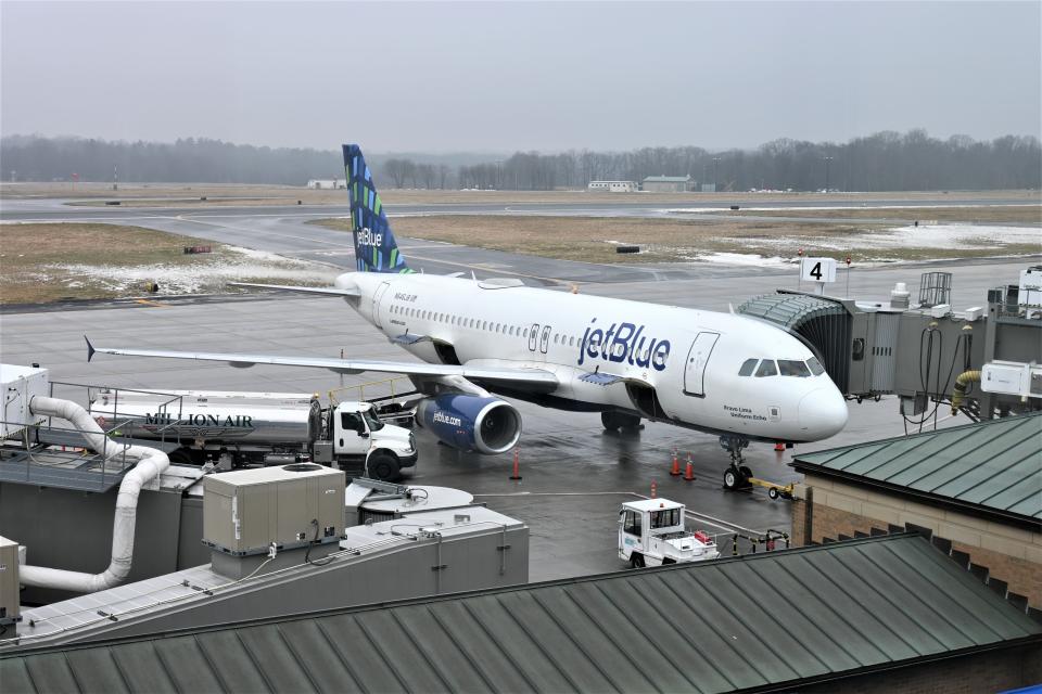A Million Air tanker helps fuel a jetBlue jet awaiting take-off at Westchester County Airport on Jan. 24, 2024.