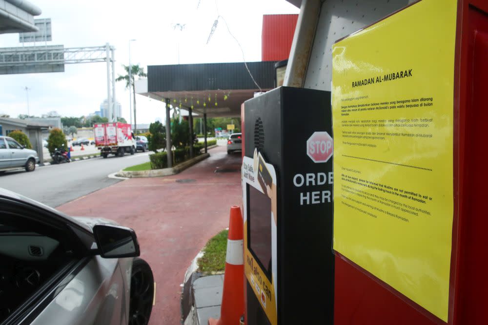 A sign restricting Muslim patrons from dining-in during the Ramadan month is seen at a McDonald’s outlet in Sunway April 29, 2022. — Picture by Choo Choy May