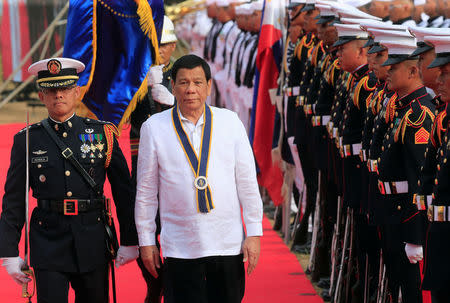 Philippine President Rodrigo Duterte reviews honour guards upon his arrival during the Philippine Navy's 120th anniversary in Metro Manila, Philippines May 22, 2018. REUTERS/Romeo Ranoco