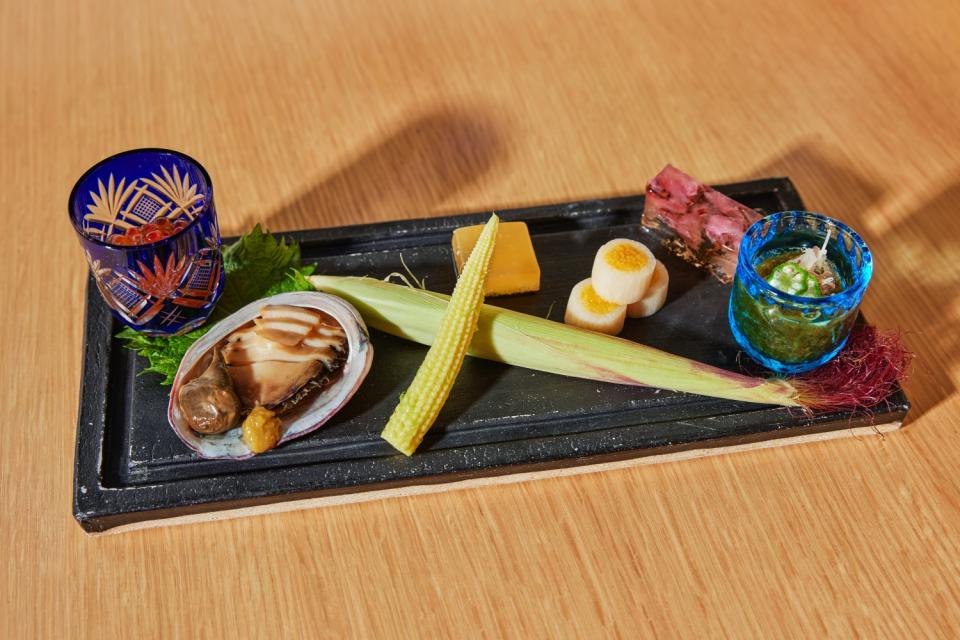 A zensai plate of baby corn and other small bites.