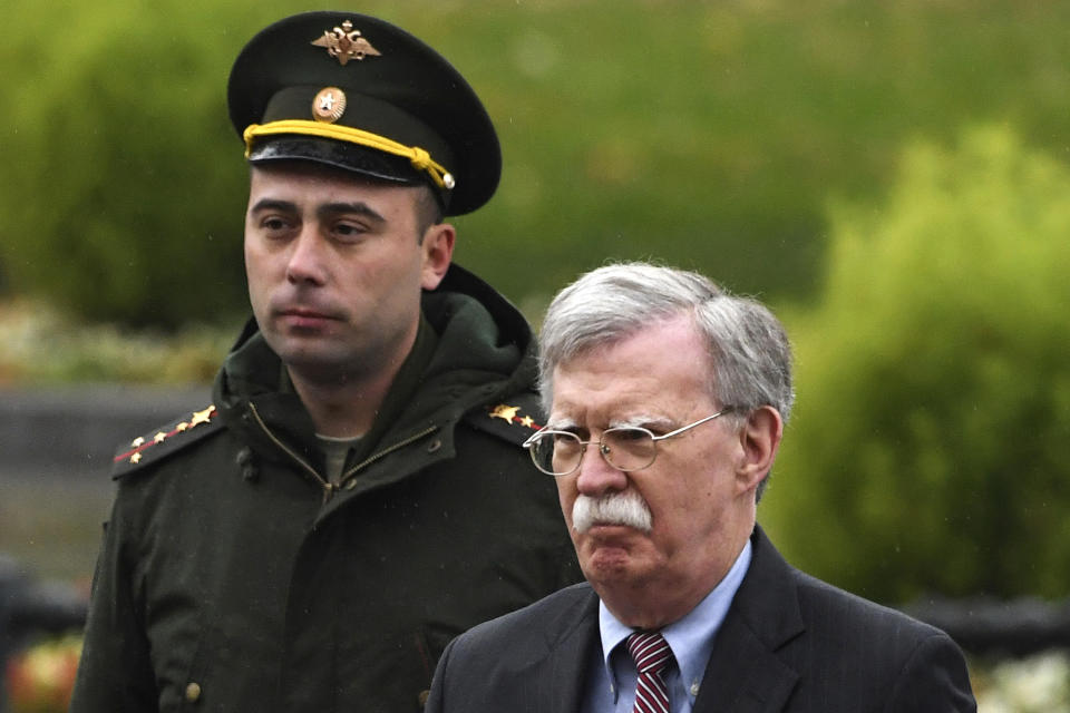 U.S. National Security Adviser John Bolton, right, attends a wreath laying ceremony at the Tomb of the Unknown Soldier by the Kremlin wall in Moscow, Russia, Tuesday, Oct. 23, 2018. U.S. President Donald Trump's national security adviser Bolton struck a conciliatory note Tuesday in talks in Moscow, just days after Trump vowed to pull out of a key arms control treaty with Russia. (Kirill Kudryavtsev/Pool Photo via AP)