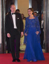 <p>Kate’s gorgeous royal blue gown for the Bollywood Charity Gala was designed by her go-to party brand, Jenny Packham. The fabric was hand-beaded in India and was paired with a matching embellished cape and bag. </p><p><i>[Photo: PA]</i></p>