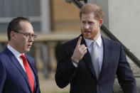 Britain's Prince Harry gestures in the gardens at Buckingham Palace in London, Thursday, Jan. 16, 2020. Prince Harry, the Duke of Sussex will host the Rugby League World Cup 2021 draw at Buckingham Palace, prior to the draw, The Duke met with representatives from all 21 nations taking part in the tournament, as well as watching children from a local school play rugby league in the Buckingham Palace gardens. (AP Photo/Kirsty Wigglesworth)
