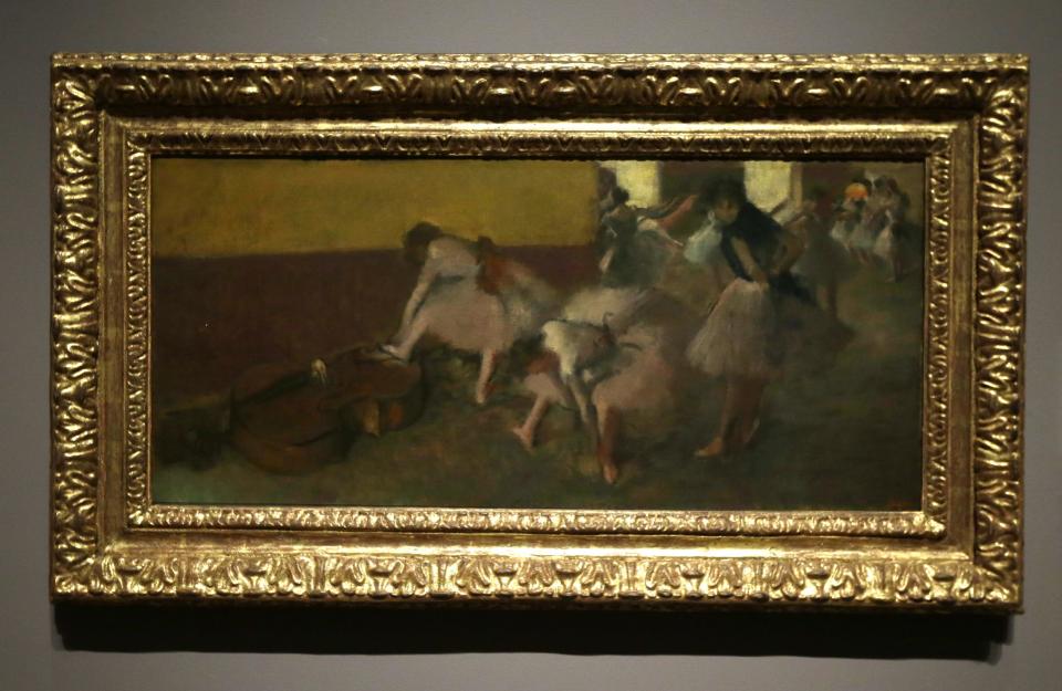 In a photo from Tuesday, Dec. 10, 2013 at the Detroit Institute of Arts in Detroit, the painting "Dancers in the Green Room" by Edgar Degas, a painting owned by the city of Detroit, is displayed. The fate of Detroit’s art is one of the sorer points amid the city's march into bankruptcy. The city purchased many of the pieces in the collection years ago during more prosperous times, which means the works that many consider part of the cultural soul of the city could be considered assets in the bankruptcy to help pay off creditors. (AP Photo/Carlos Osorio)