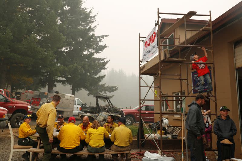 A boy climbs a scaffolding at the Hansen family farm, where members of the Hillbilly Brigade and firefighters from all over came to rest and eat during their work in the aftermath of the Riverside Fire near Molalla, Oregon