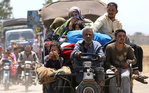 Refugees from Daraa province arrive near the Israeli-occupied Golan Heights in Quneitra, Syria.  - Credit: Alaa Faqir/Reuters 