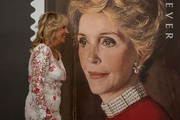 First lady Jill Biden stands next to a giant picture of former first lady Nancy Reagan's face. (Photo: Kent Nishimura via Getty Images)