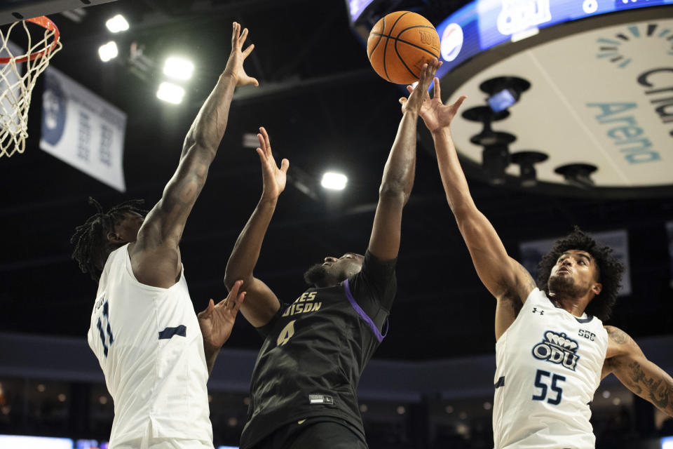 James Madison guard Bryant Randleman (4) shoots over Old Dominion forward Dani Pounds (11) and guard Bryce Baker (55) during the first half of an NCAA college basketball game Saturday, Dec. 9, 2023, in Norfolk, Va. (AP Photo/Mike Caudill)