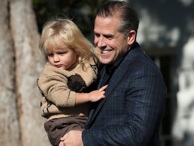 <p>Win McNamee/Getty</p> Hunter Biden holds his son Beau Jr. as they arrive for the National Thanksgiving Turkey pardoning ceremony in November 2022.