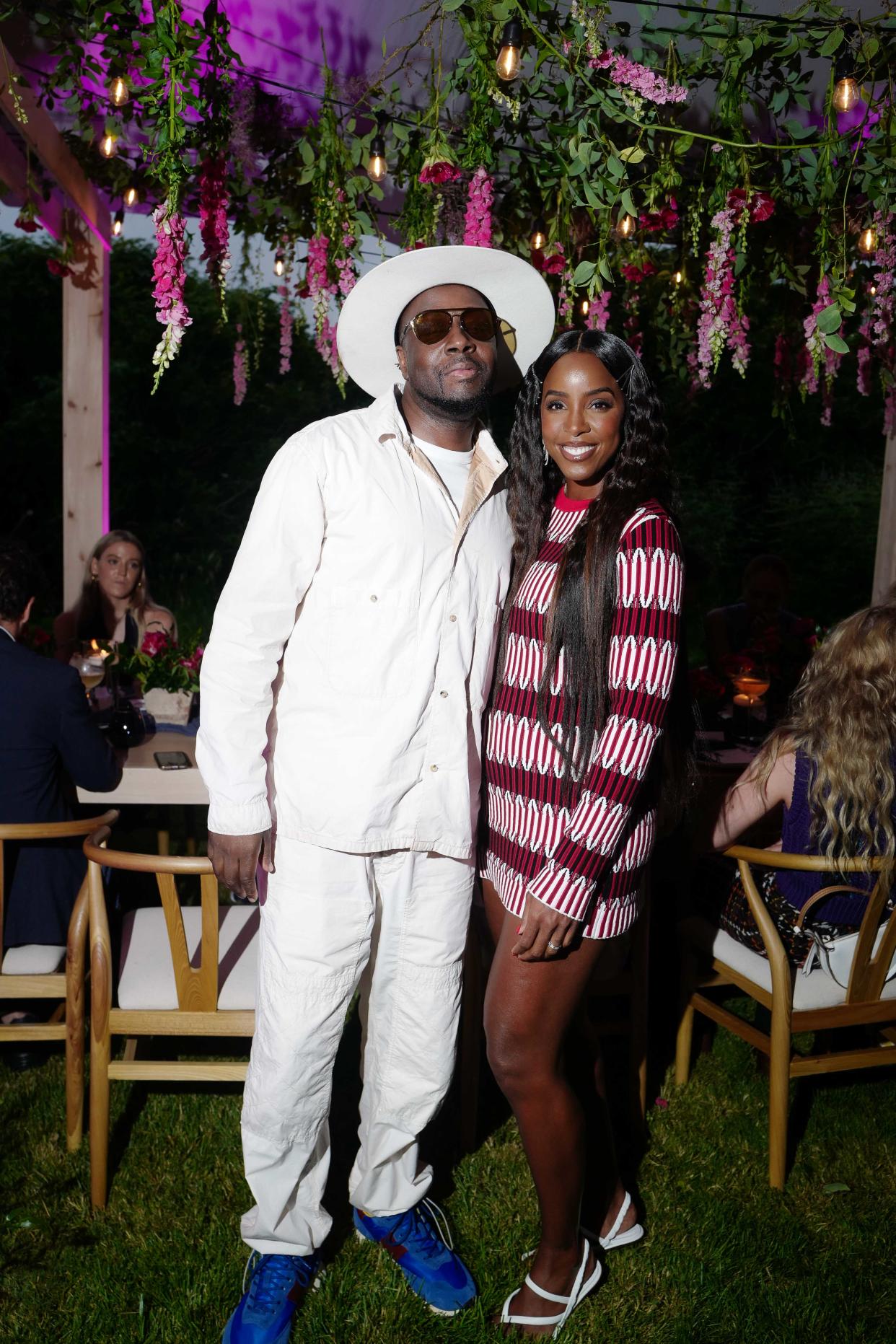 Kelly Rowland poses with Wyclef Jean at Tod’s “Summer in the Hamptons” dinner on Thursday, July 21. - Credit: BFA