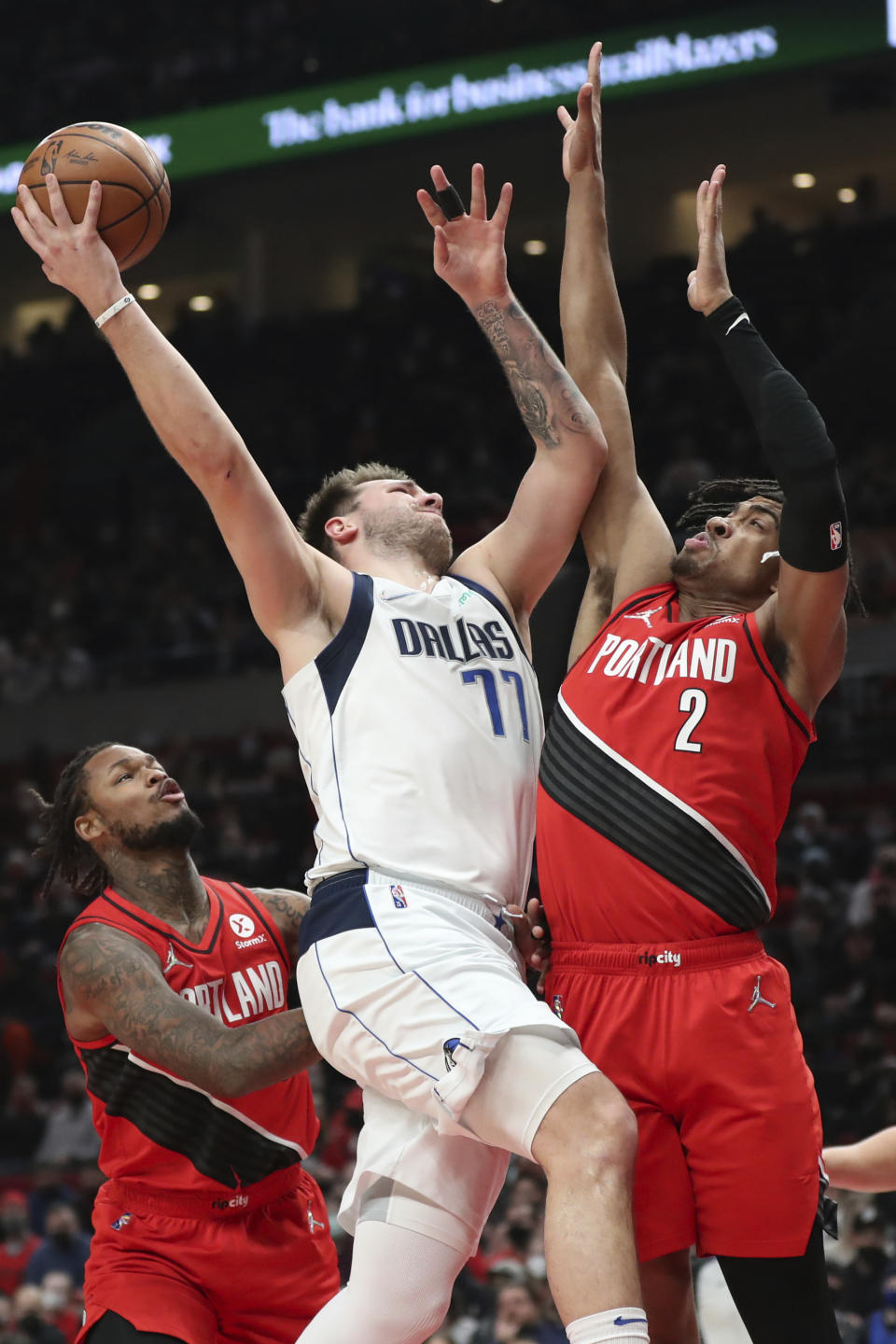 Dallas Mavericks guard Luka Doncic collides with Portland Trail Blazers forward Trendon Watford during the first half of an NBA basketball game in Portland, Ore., Wednesday, Jan. 26, 2022. (AP Photo/Amanda Loman)