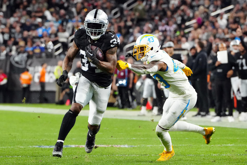 Dec 14, 2023; Paradise, Nevada, USA; Las Vegas Raiders running back Brandon Bolden (34) runs for a touchdown against Los Angeles Chargers cornerback Michael Davis (43) in the second quarter at Allegiant Stadium. Mandatory Credit: Stephen R. Sylvanie-USA TODAY Sports