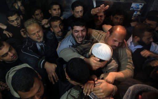 Palestinians mourn in a hospital after two militants of the Al Quds Brigades, the military arm of Islamic Jihad, were killed in an Israeli air strike in Gaza City