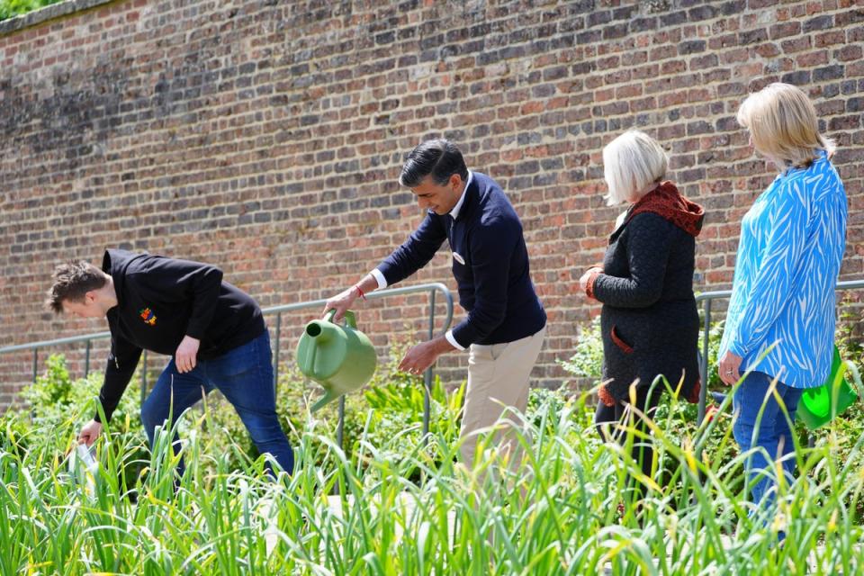 Prime Minister Rishi Sunak using a watering can during a visit to Big Help Out project in Bishop Auckland, County Durham (Peter Byrne/PA) (PA Wire)