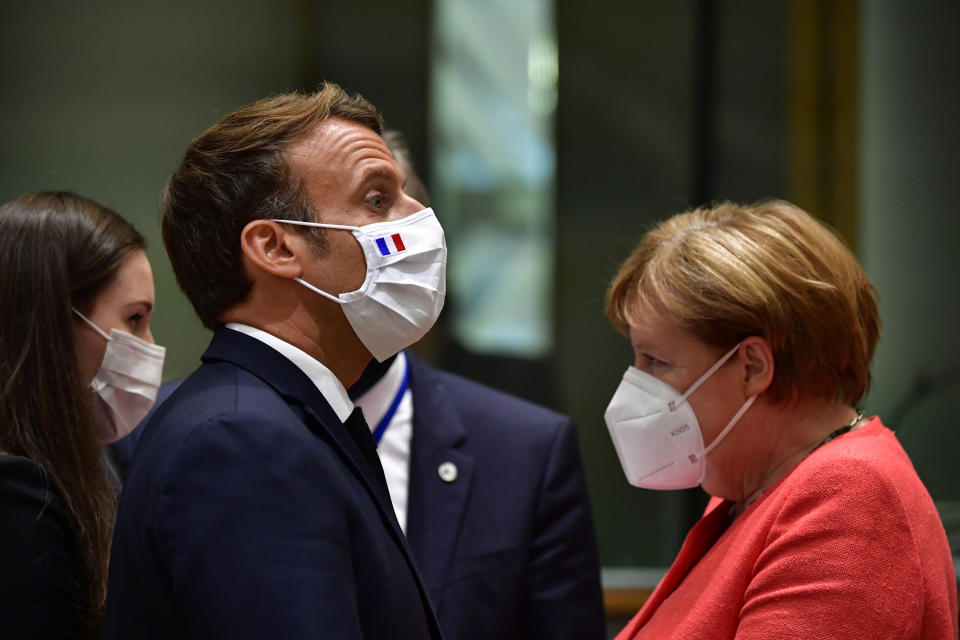 From left, Finland's Prime Minister Sanna Marin, French President Emmanuel Macron and German Chancellor Angela Merkel attend a round table meeting at an EU summit in Brussels, Monday, July 20, 2020. Weary European Union leaders are expressing cautious optimism that a deal is in sight on their fourth day of wrangling over an unprecedented budget and coronavirus recovery fund. (John Thys, Pool Photo via AP)