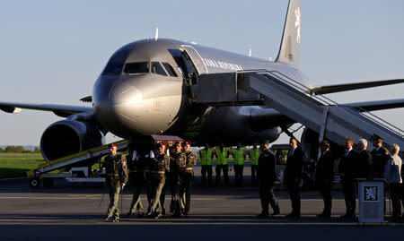 Soldiers carry a coffin with the remains of Czech cardinal Josef Beran after its arrival to Kbely airport in Prague, Czech Republic, April 20, 2018. REUTERS/David W Cerny