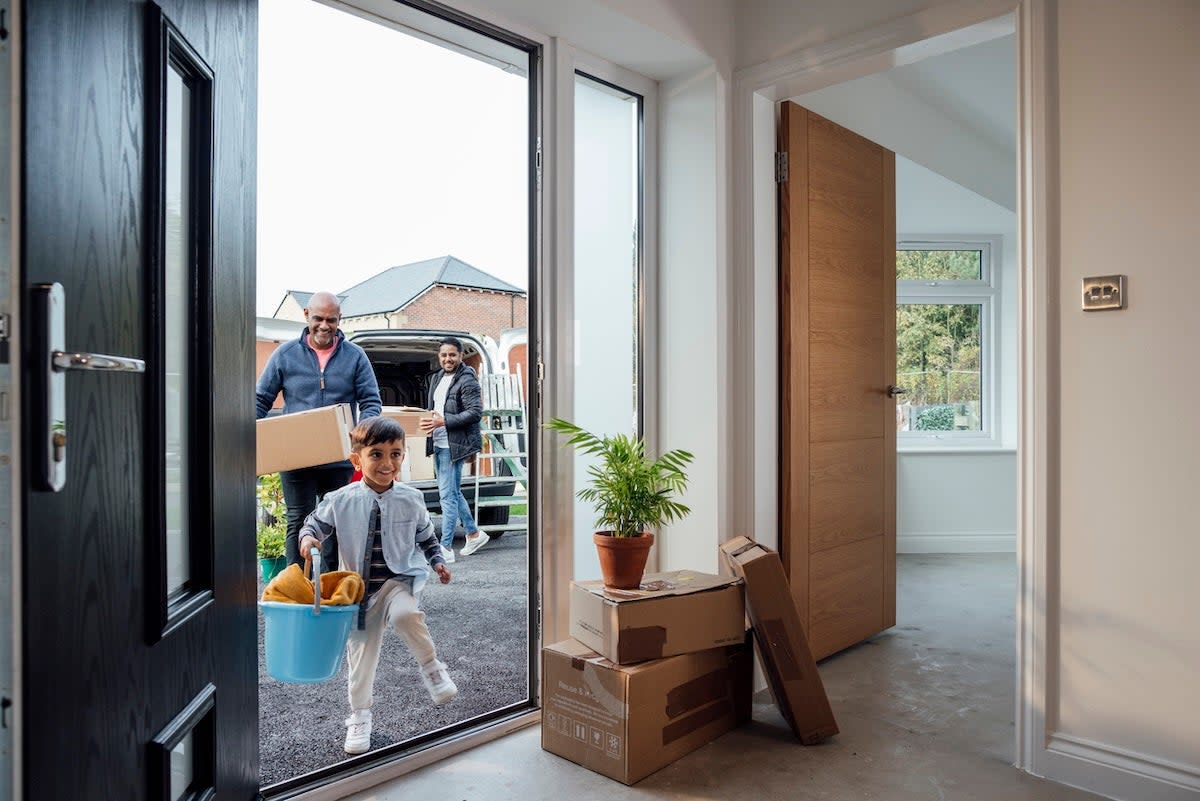 A grandfather, father, and son moving into a new home.