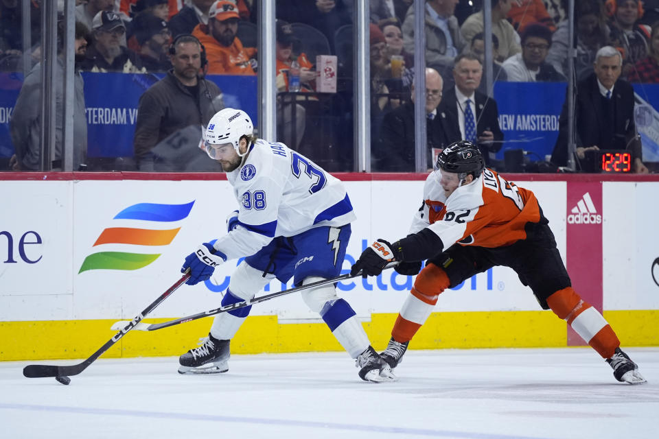 Tampa Bay Lightning's Brandon Hagel, left, keeps away from Philadelphia Flyers' Olle Lycksell during the second period of an NHL hockey game, Tuesday, Feb. 27, 2024, in Philadelphia. (AP Photo/Matt Slocum)