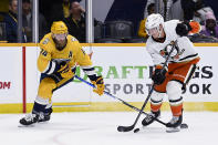 Anaheim Ducks center Ryan Strome (16) gets control of the puck as Nashville Predators defenseman Mattias Ekholm (14) defends during the first period of an NHL hockey game Tuesday, Nov. 29, 2022, in Nashville, Tenn. (AP Photo/Mark Zaleski)