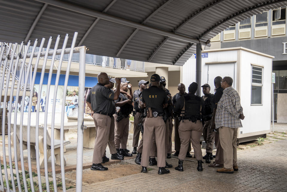 Prison officials seen at the Department of Correctional Services Headquarters in Pretoria, South Africa, Friday, Jan. 5, 2024 where South African athlete Oscar Pistorius was expected to be released. Pistorius has served nearly nine years of his 13 years and five months murder sentence for killing girlfriend Reeva Steenkamp on Valentine’s Day 2013. (AP Photo/Shiraaz Mohamed)