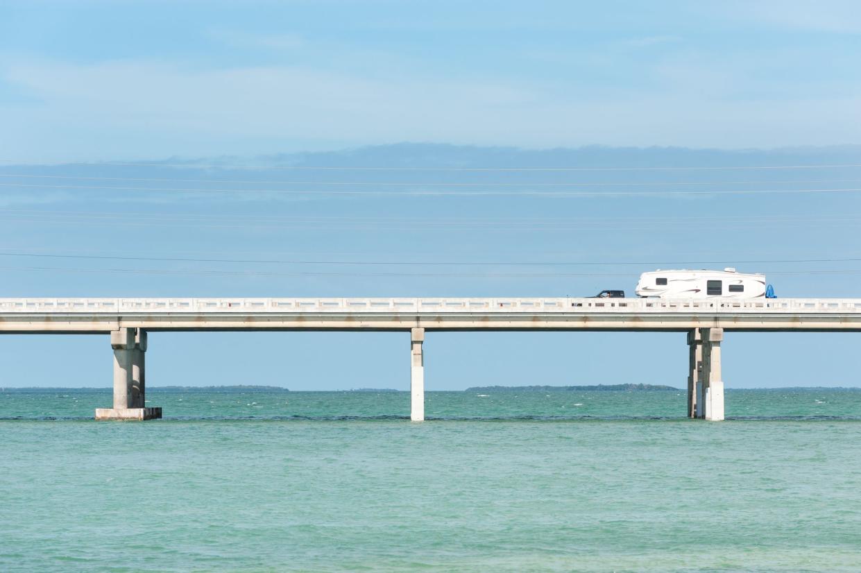 RV traveling on Seven Mile Bridge of Overseas Highway between the Florida Keys with the ocean and sky