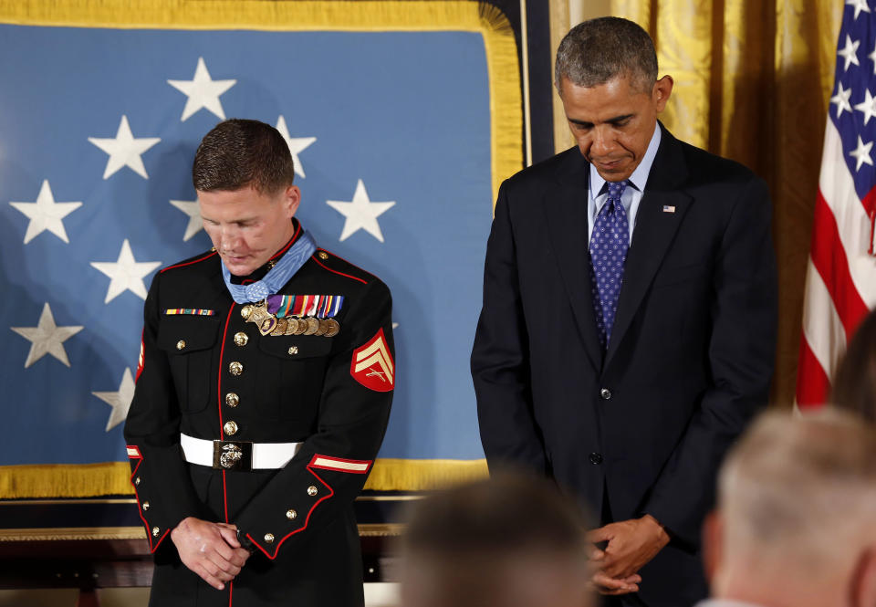 Obama prays after presenting the Medal of Honor to retired U.S. Marine Corps Corporal Carpenter during a ceremony in the East Room of the White House in Washington